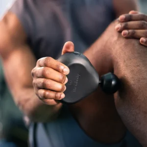 Theragun or massage gun in use – a recovery tool for muscle soreness.