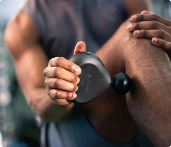 Theragun or massage gun in use – a recovery tool for muscle soreness.